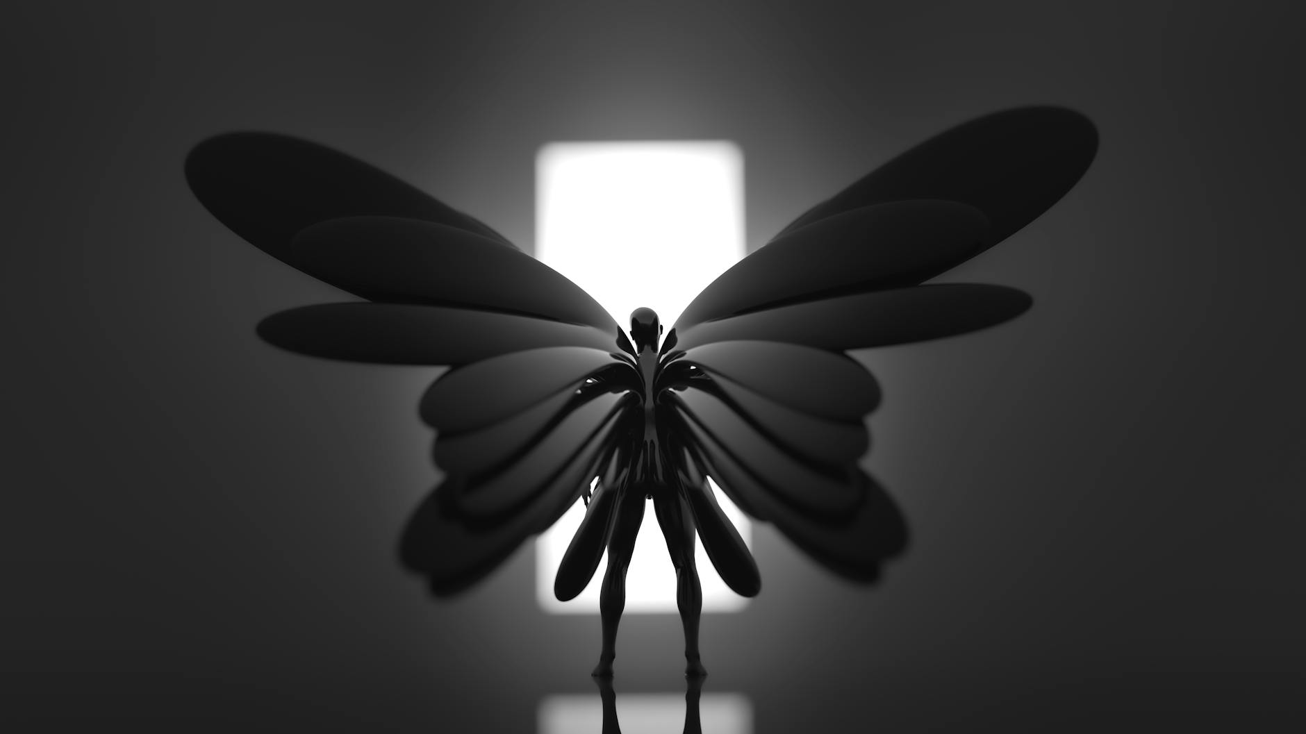 Artistic and abstract figure with large wings in dramatic black and white lighting.