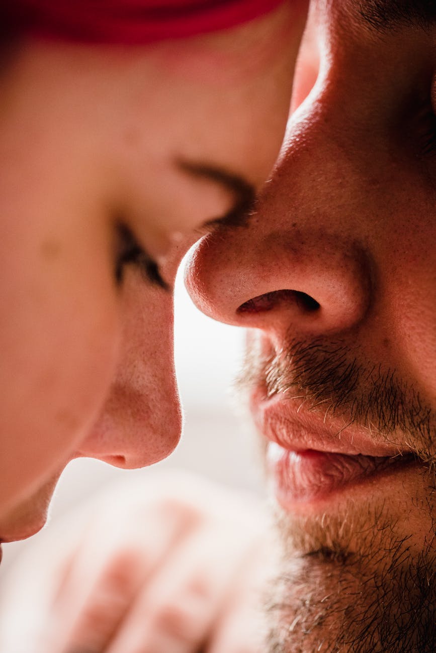 A close-up photo capturing an intimate moment between a couple sharing affection.