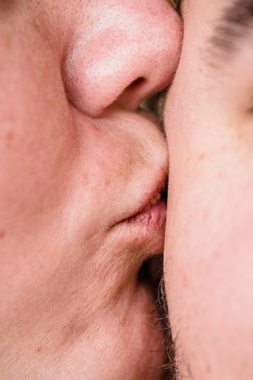 Intimate close-up of two people kissing, highlighting affection and connection.