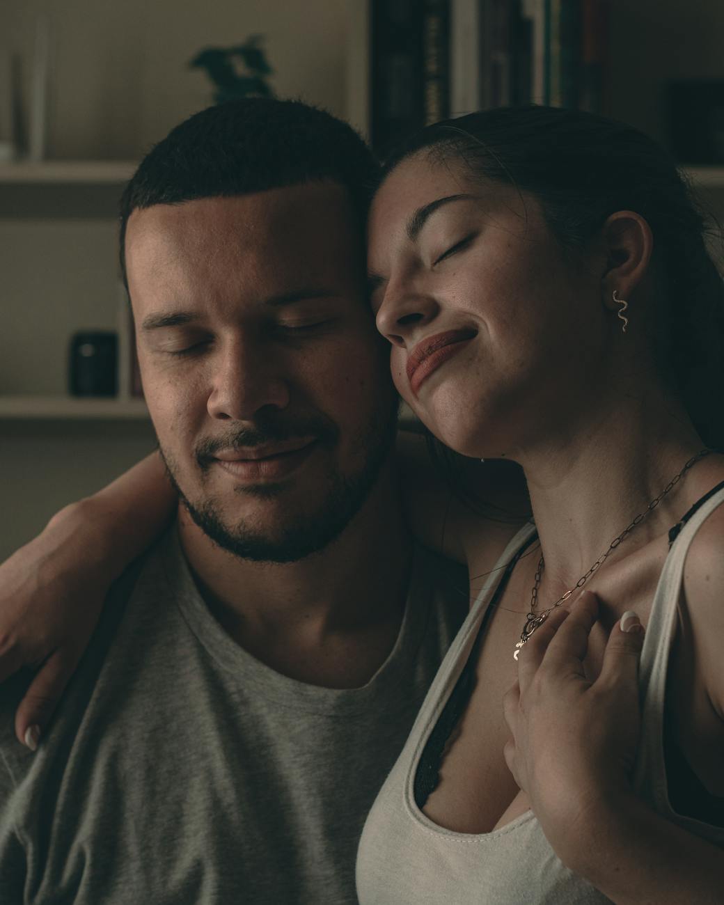 A loving couple sharing a tender embrace inside a cozy home.