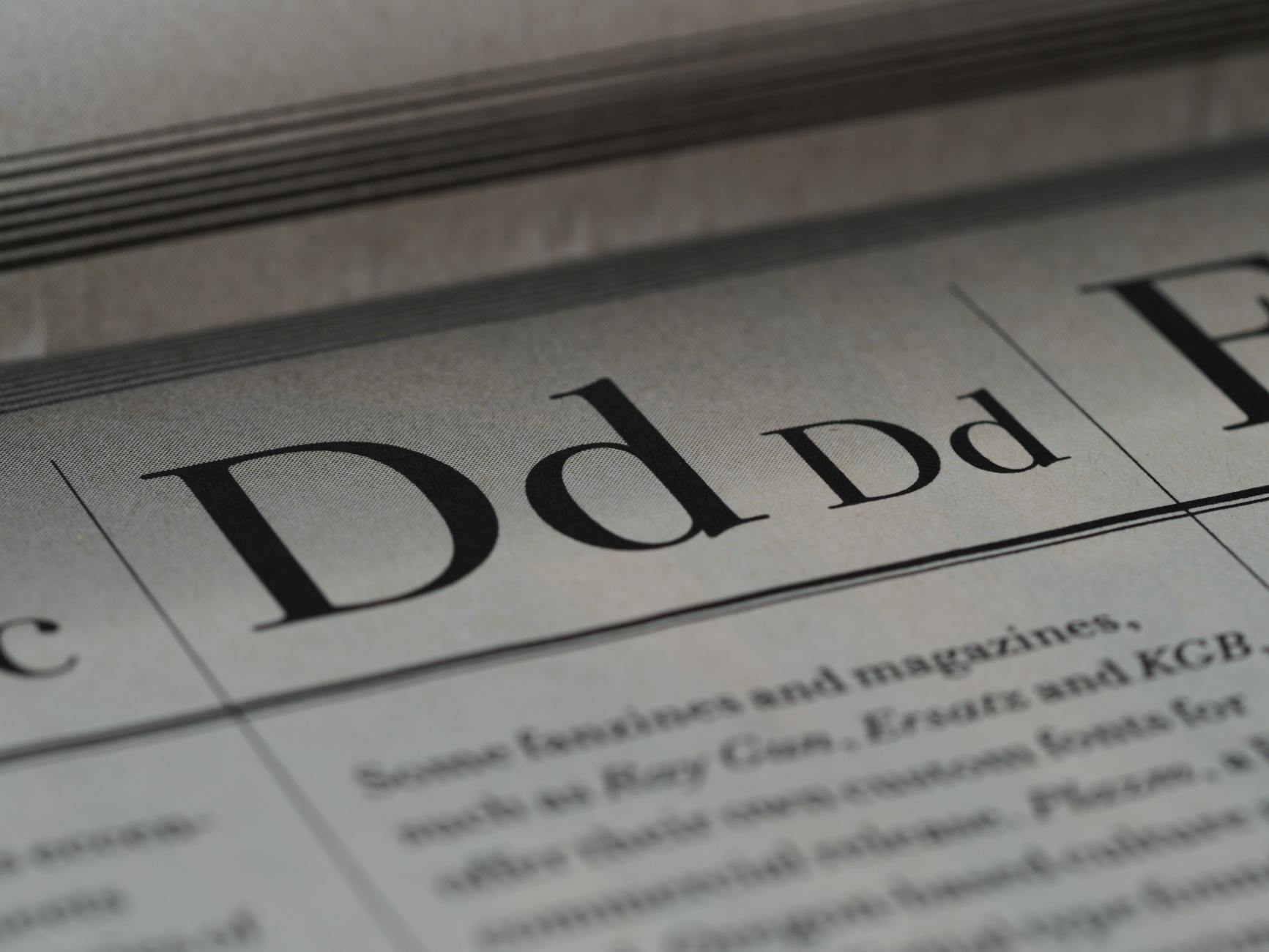Detailed close-up of a newspaper showing typography and lettering design.